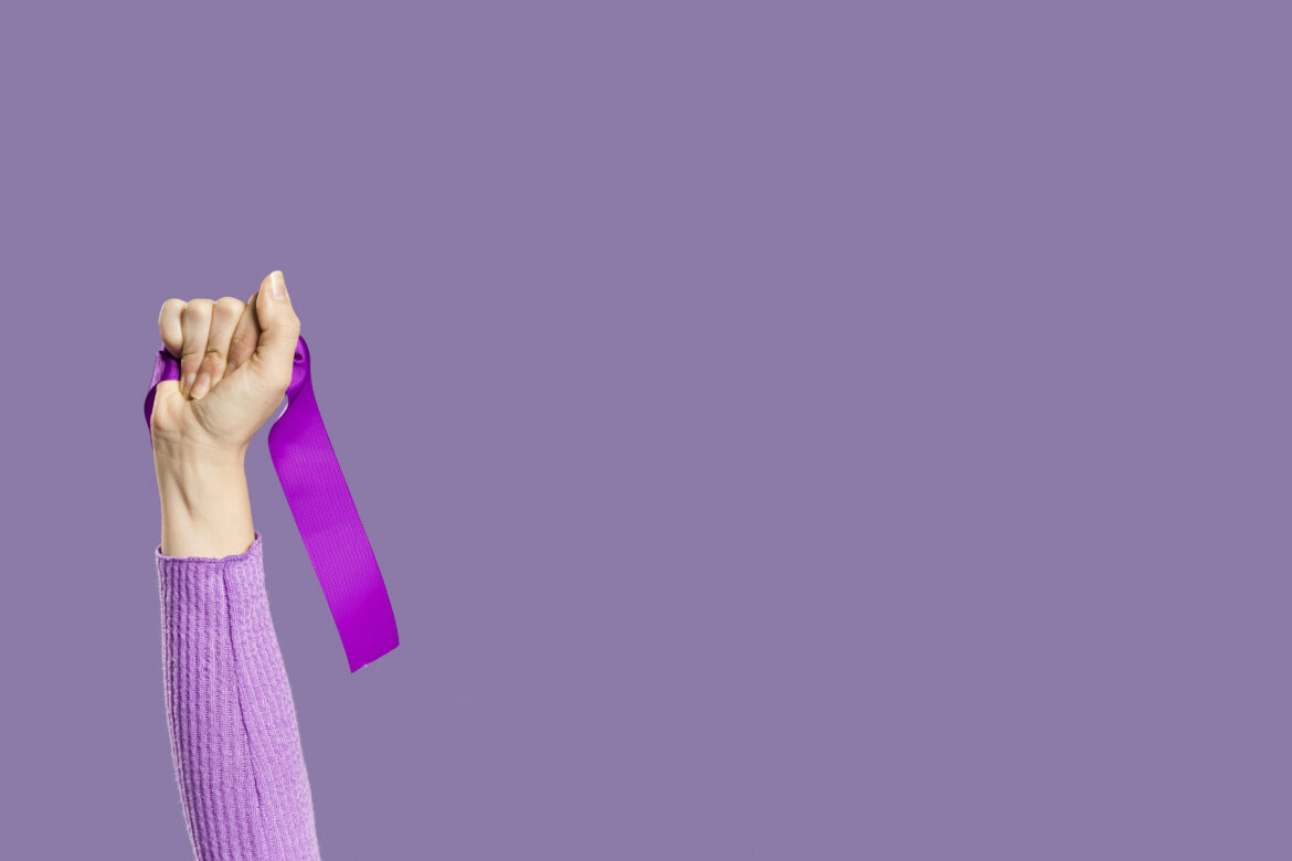 woman-s-hand-holding-violet-ribbon-copy-space
