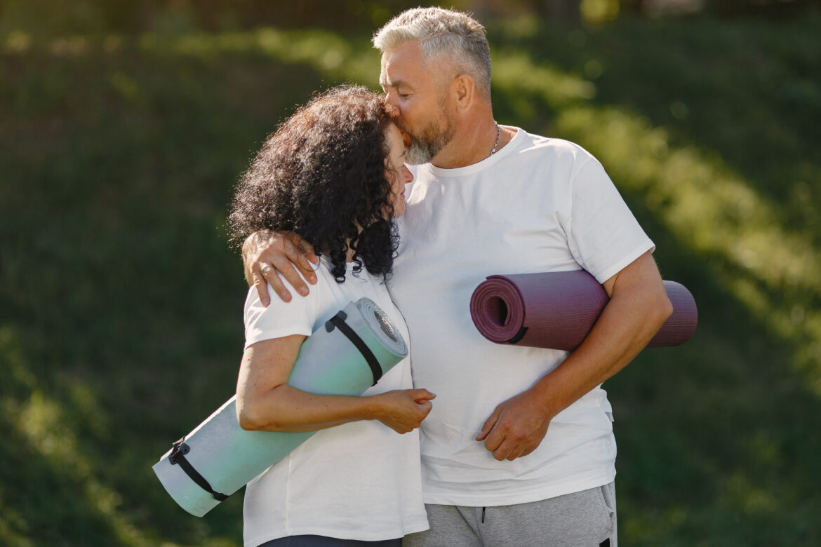 Happy elderly senior couple doing yoga