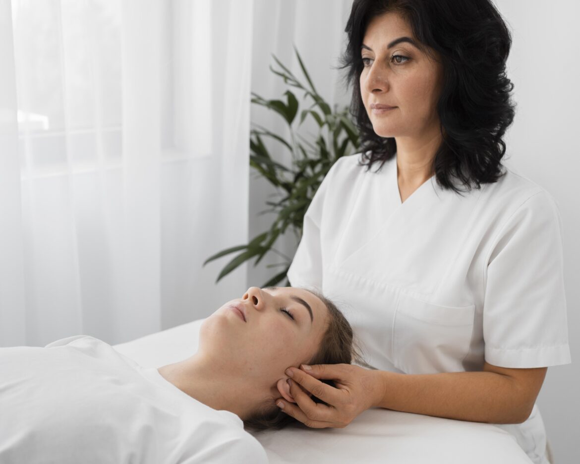 female-osteopathist-treating-patient-indoors